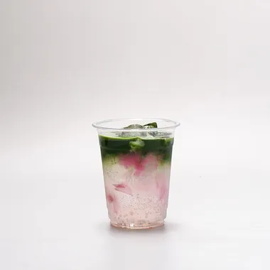 Clear cup, matcha layered dark green over pink sakura sparkling and ice